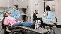 two dentists performing parallel exams in clinic setting